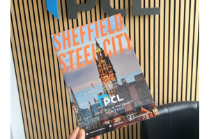 The Sheffield Brochure in front of the PCL logo